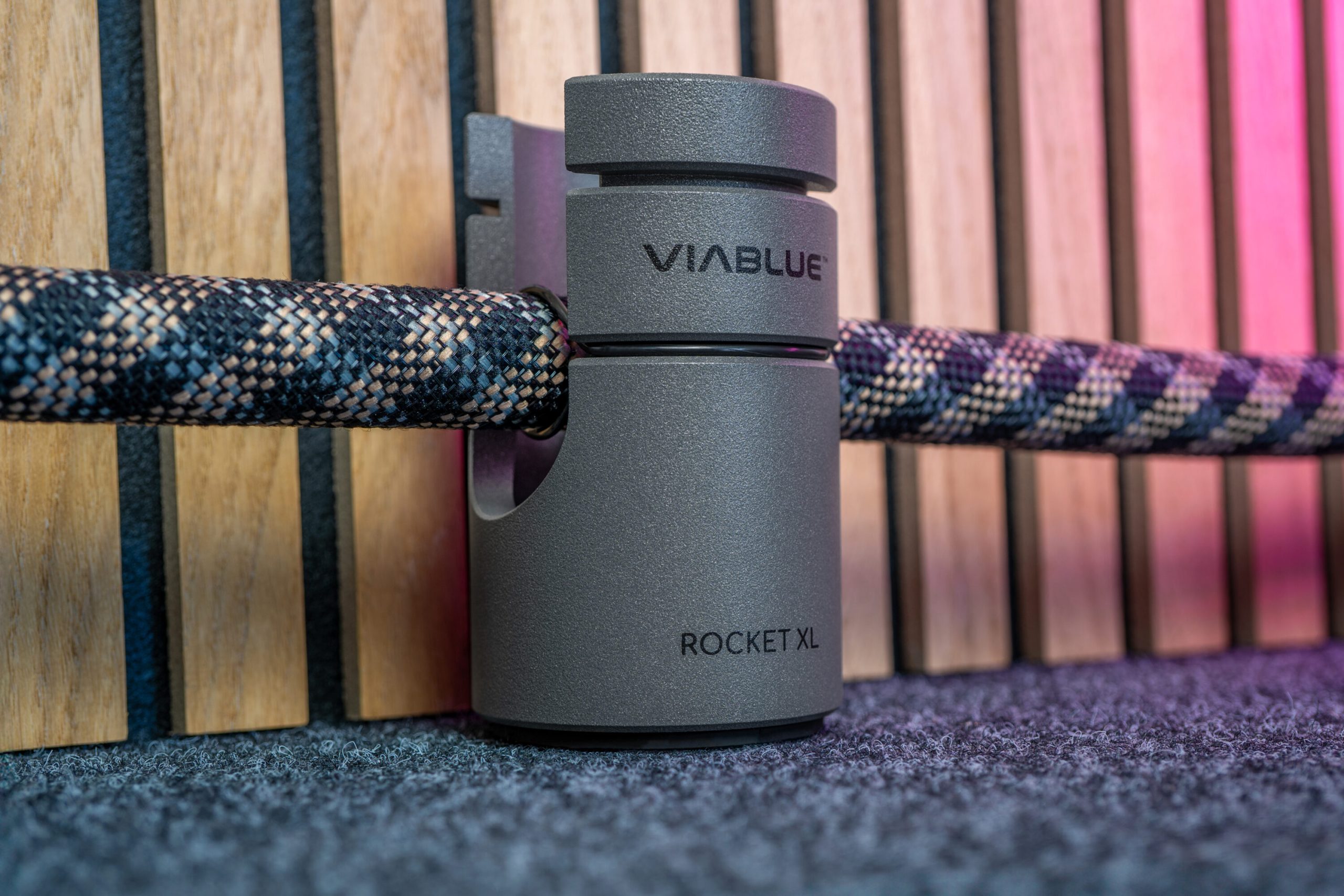 VIA BLUE Rocket XL cable holder on carpet, featuring sleek design and ergonomic grip for organized home theater setup.