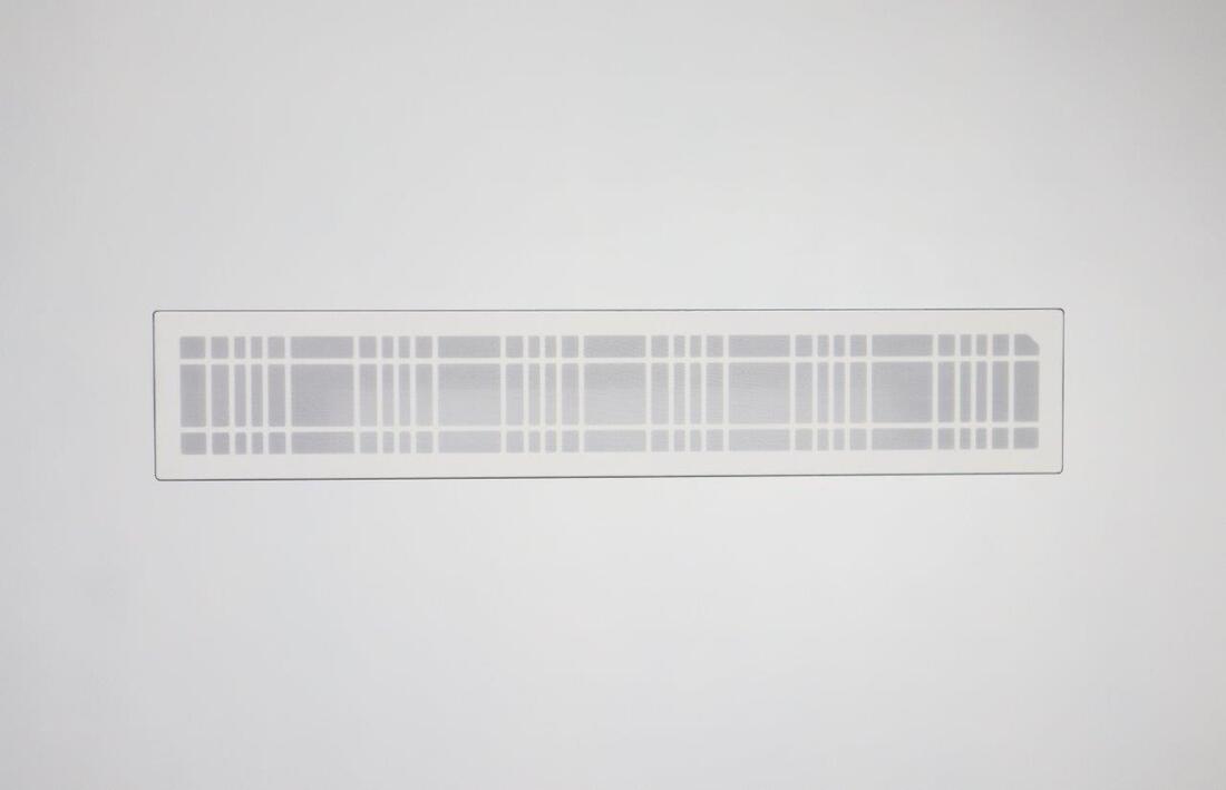 Modern wall-mounted speaker grill with a sleek design fitting for a home theater setup, enhancing acoustics and aesthetics.