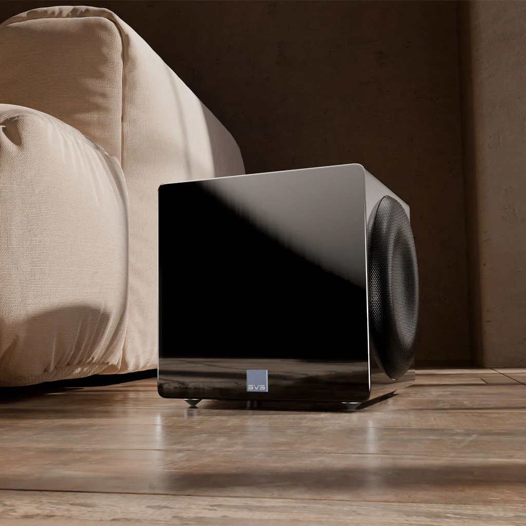 Sleek SVS subwoofer positioned near a cozy couch, enhancing the aesthetic of a modern home theater setup.