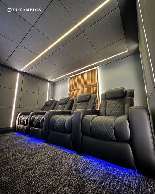 Luxury home theater with integrated architectural lighting, concealed LED lighting, and layered ambient illumination.