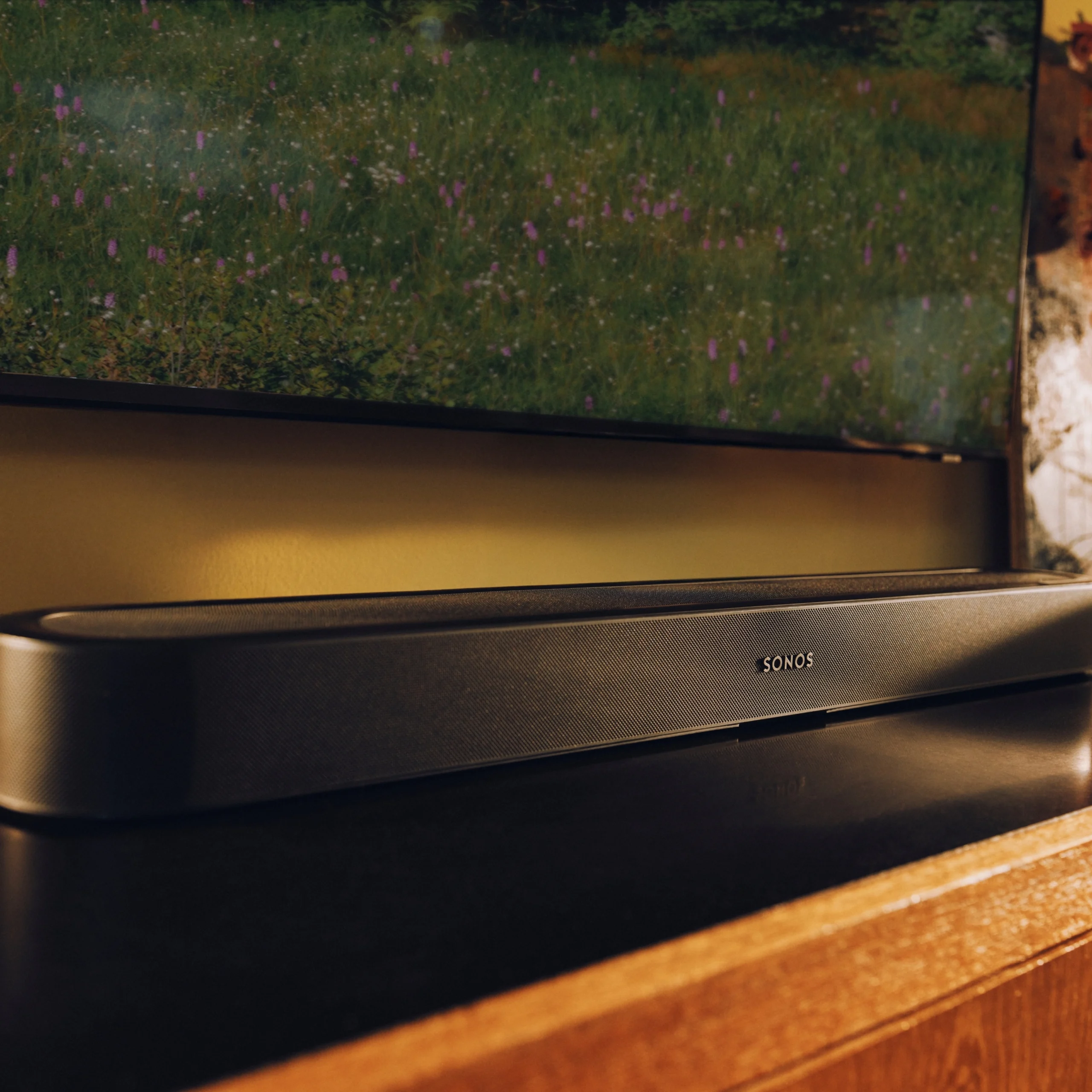 A sleek Sonos soundbar positioned below a television, enhancing home audio for an immersive viewing experience.