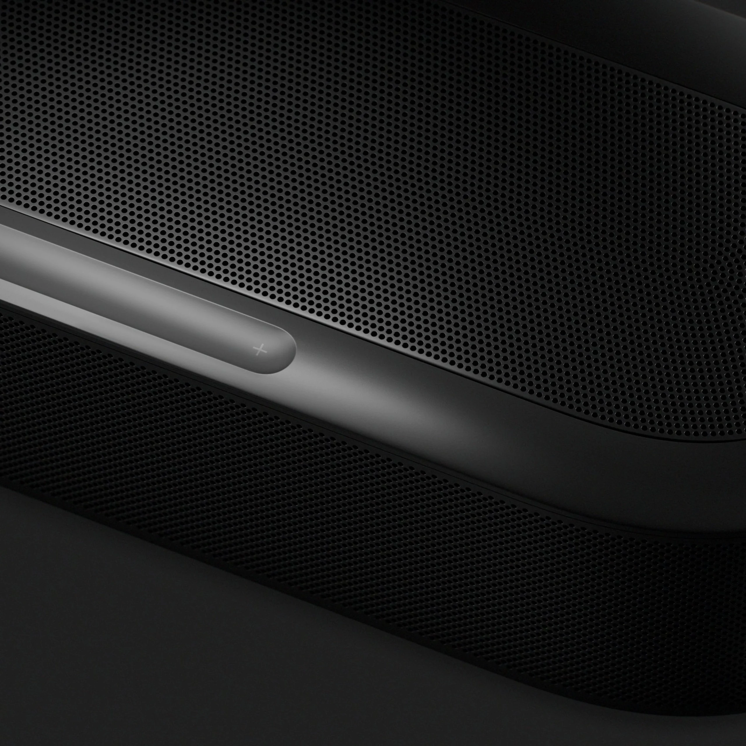 Close-up of a sleek, modern speaker design with a textured black grille and a subtle control button. Ideal for audio enthusiasts.