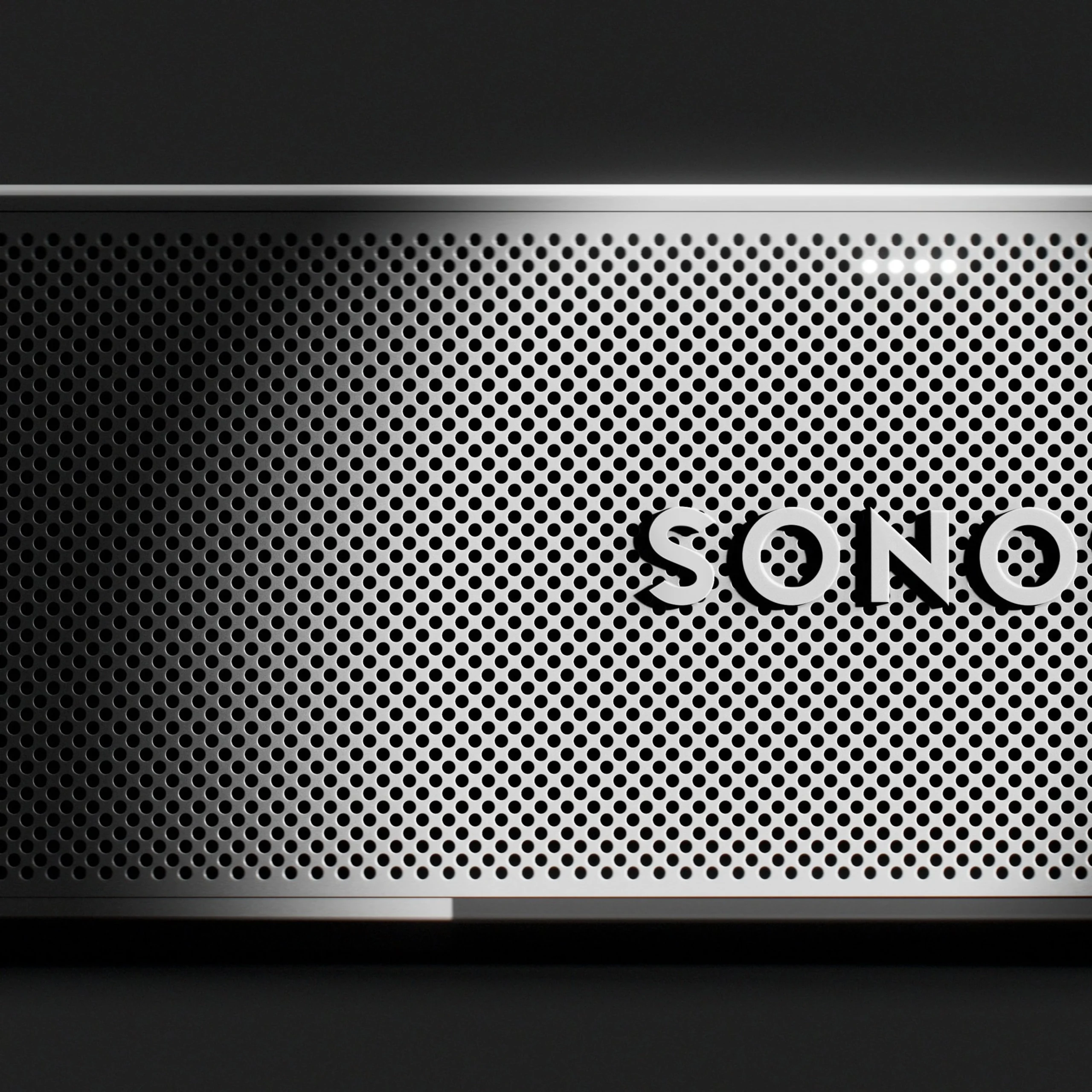 Sleek speaker design featuring perforated metal grille and modern logo, ideal for enhancing home audio experiences.