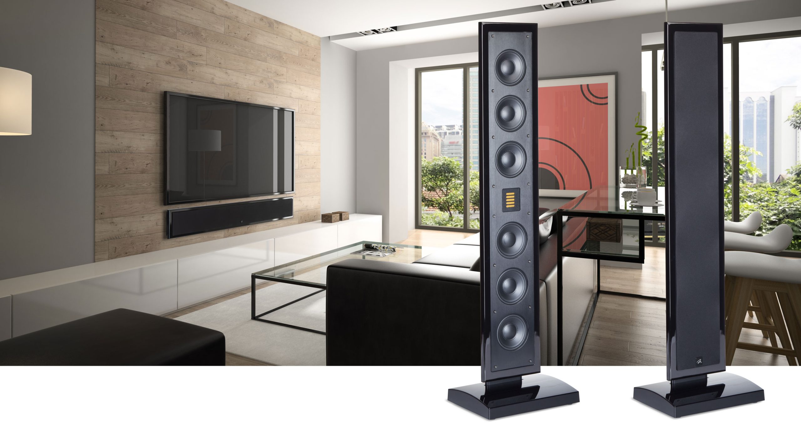 Stylish floor-standing speakers complementing a modern living room with a wall-mounted TV and glass coffee table.